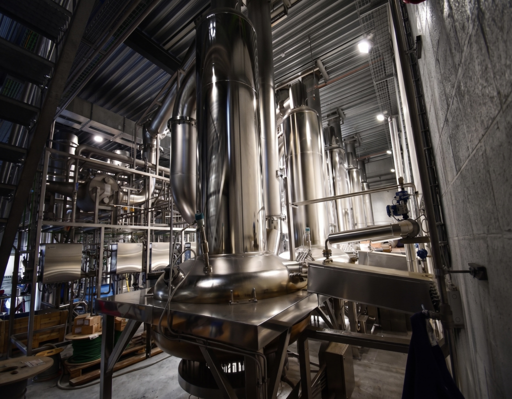 Interior view of stainless steel process columns and piping in a specialty gas purification plant